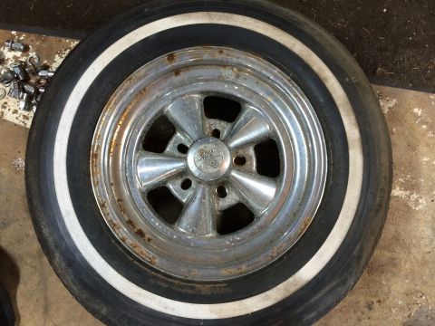 1964 Ford Fairlane - A chrome five-spoke wheel with a whitewall tire shows signs of rust and wear.