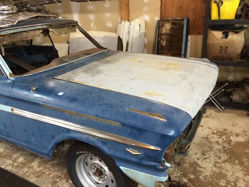 1964 Ford Fairlane front clip with blue paint and chrome trim, hood is primer gray