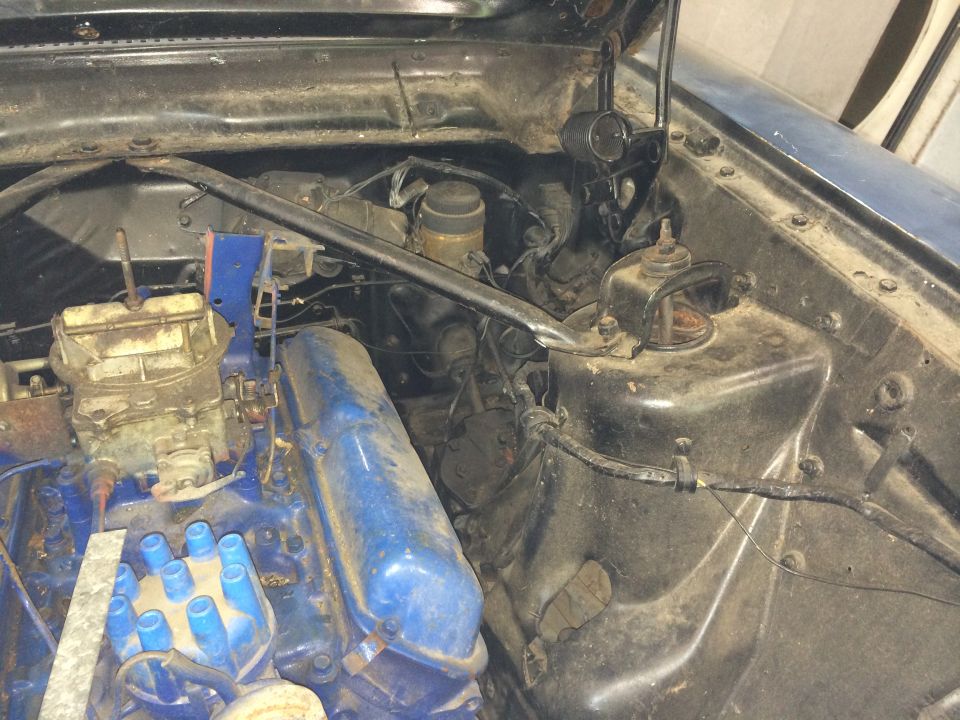 1964 Ford Fairlane engine bay with blue valve covers and carburetor