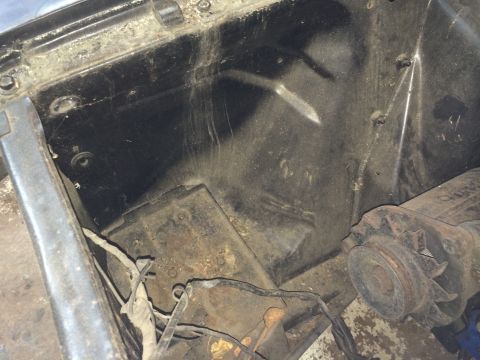1964 Ford Fairlane - Close-up view of a dusty and somewhat corroded engine bay, showing mechanical components and wiring.