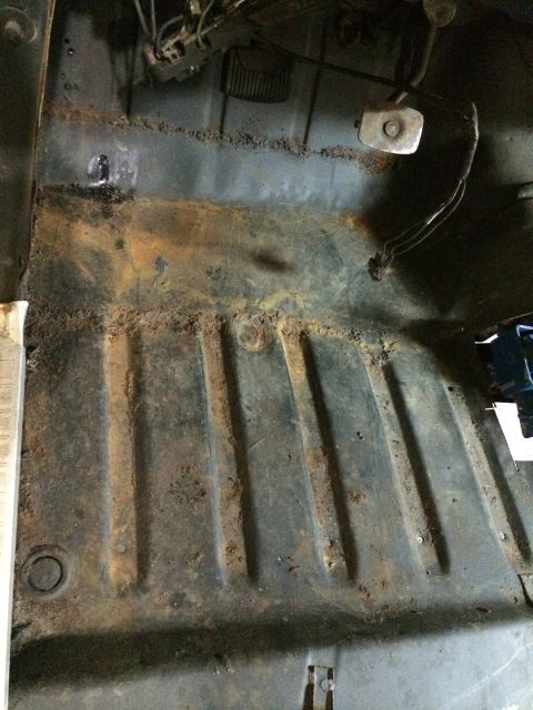 1964 Ford Fairlane - The interior floor pan shows significant rust and wear, with brake and accelerator pedals visible.