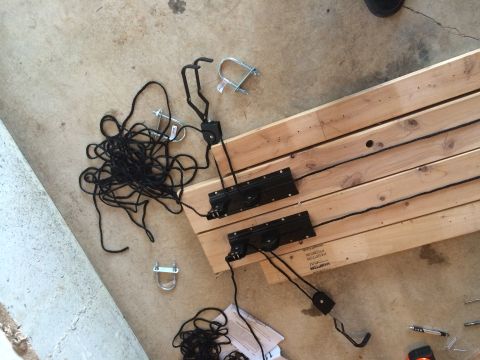 1989 Ford Bronco - A collection of ropes, pulleys, and hardware are laid out on wooden planks on a concrete surface.
