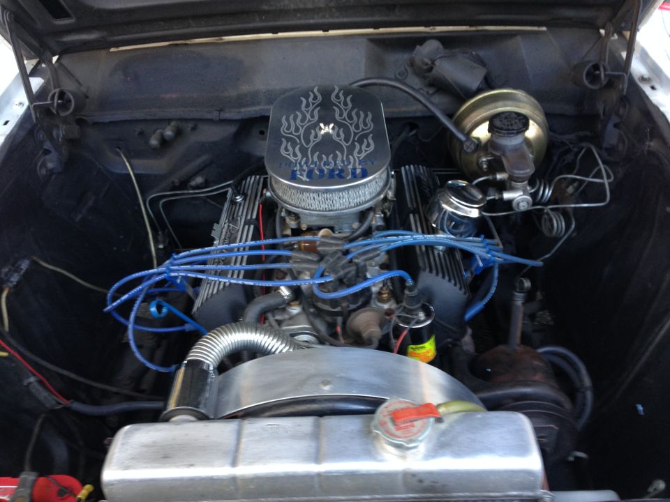 Engine bay with V8 engine, chrome air cleaner with flame decals, and blue spark plug wires