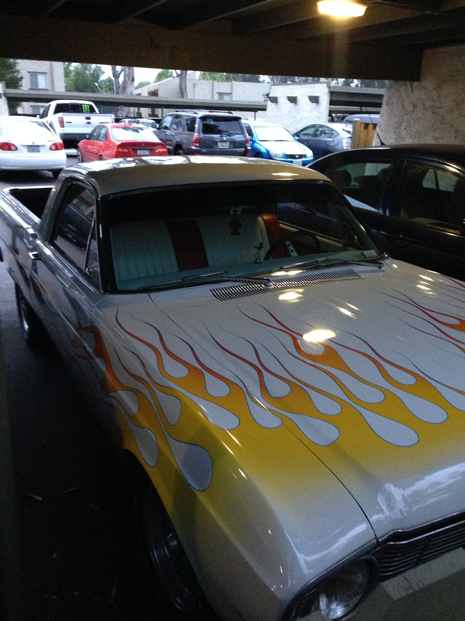 1966 Ford Ranchero with flame decals, silver paint, and red/white interior