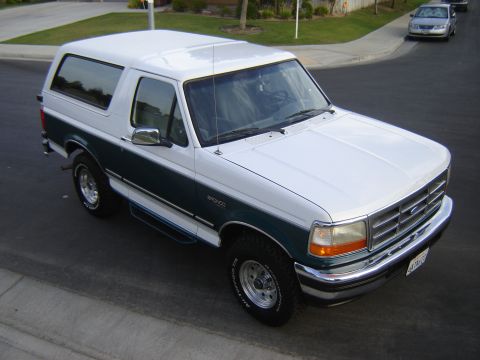 1996 Ford Bronco - This two-tone Ford Bronco is shown from a high angle on a suburban street.