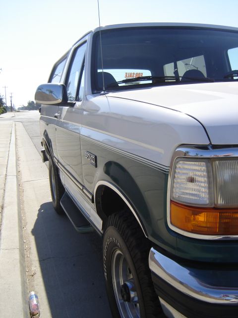 1996 Ford Bronco - This 1996 Ford Bronco is parked on the side of a street on a sunny day.
