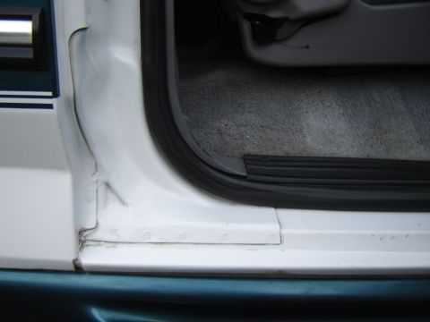 1996 Ford Bronco - Close-up view of the interior door frame and carpet, showing the seal and floor mat area.