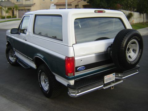 1996 Ford Bronco - The rear-view of a 1996 Ford Bronco shows its two-tone paint scheme and external spare tire.