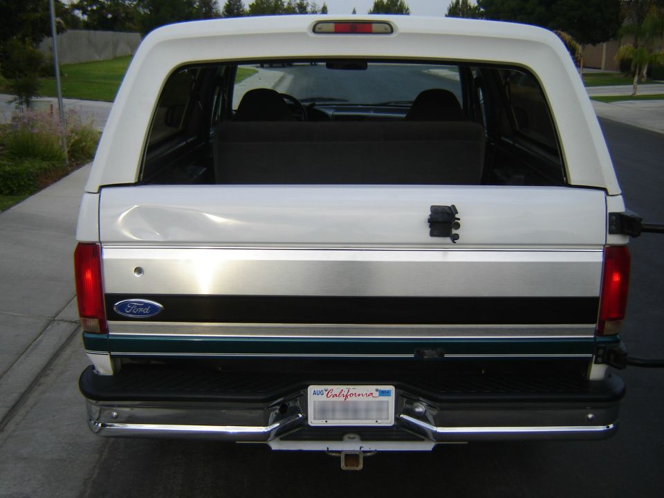 White Ford Bronco rear view, chrome bumper, California license plate