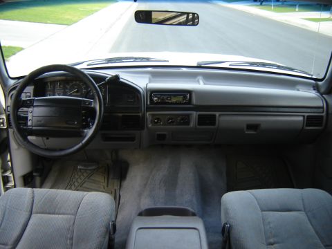 1996 Ford Bronco - The interior of a 1996 Ford Bronco shows a gray dashboard, steering wheel, and seats.