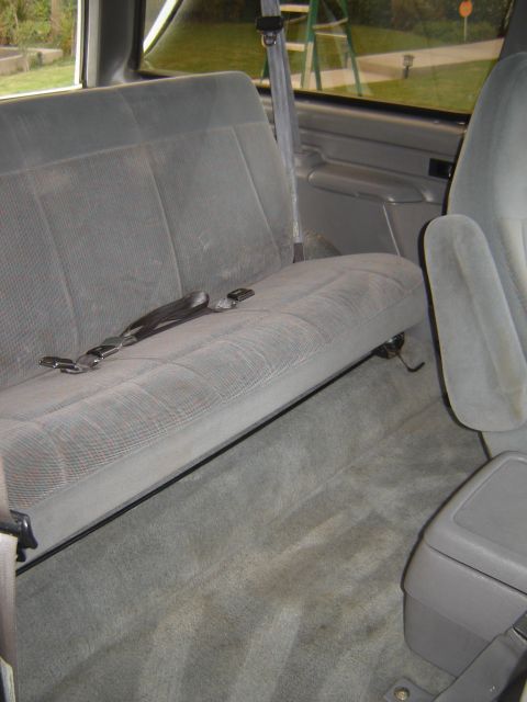 1996 Ford Bronco - Interior view of the rear seating area in a 1996 Ford Bronco, showing the bench seat and center console.