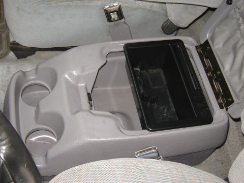 1996 Ford Bronco - Interior view of a 1996 Ford Bronco's center console, showing cup holders and storage.