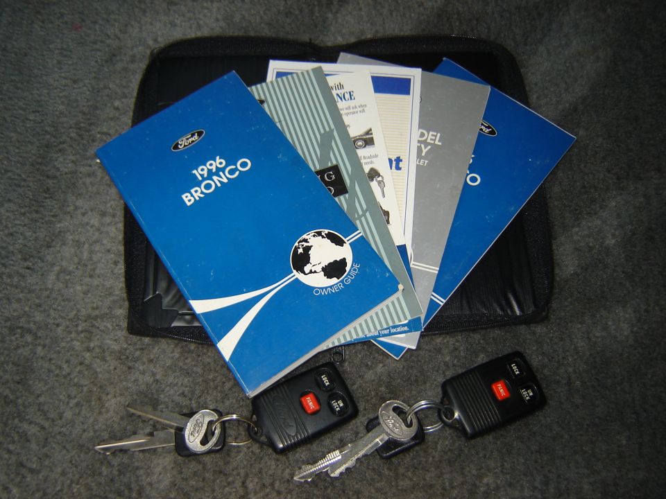 1996 Bronco owner's manual, other Ford documents, and two sets of keys on carpet