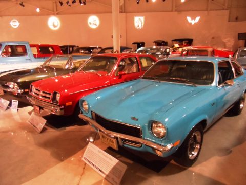 1971 Ford Ranchero - Several vintage cars are on display in a museum setting, including a blue Chevrolet Vega.