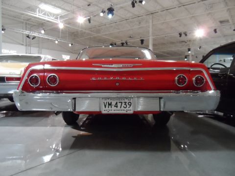 1971 Ford Ranchero - Rear view of a red 1962 Chevrolet with a Michigan license plate.