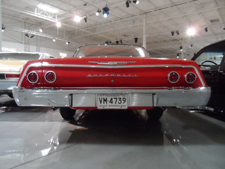 Red 1962 Chevrolet with chrome bumper and dual taillights