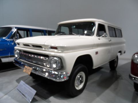 1971 Ford Ranchero - A white panel van is displayed, with a blue vehicle partially visible to the left.