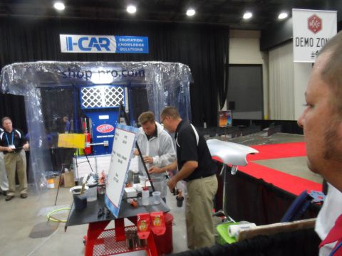 1971 Ford Ranchero - A demonstration of automotive painting techniques is underway at an indoor event.