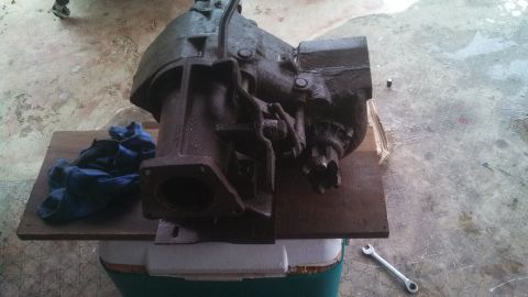 1979 Ford Bronco - This is a heavy cast iron transmission part resting on a wooden board.