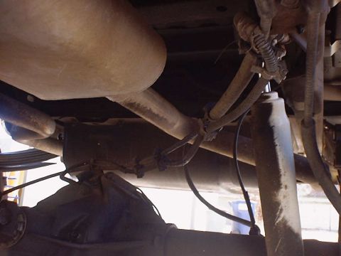1988 Ford Bronco - Underside view of a vehicle's exhaust system and rear axle components.
