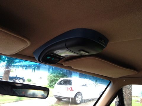 1989 Ford Bronco - Overhead console interior view with digital display and a white SUV seen through the windshield.