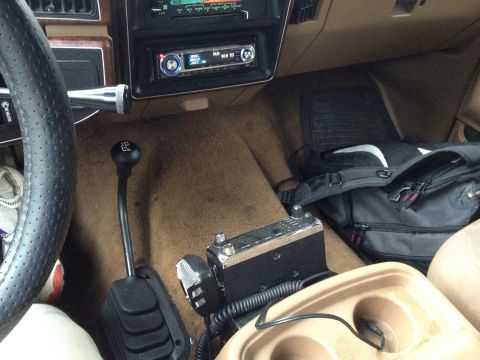 1989 Ford Bronco - The interior of a 1989 Ford Bronco features a CB radio and a 4-speed manual transmission shifter.