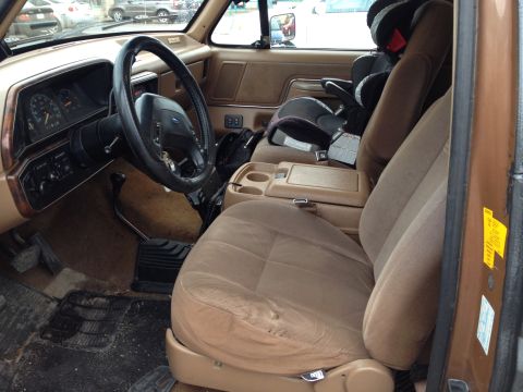 1989 Ford Bronco - Interior view of a 1989 Ford Bronco, equipped with a child car seat.