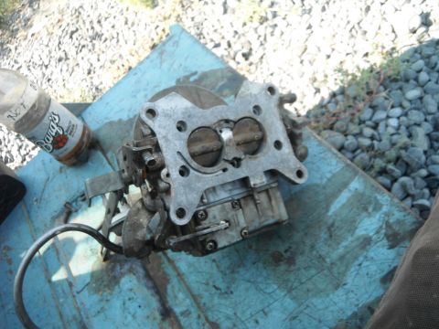 1972 International Scout II - A carburetor sits on a blue surface, accompanied by a bottle of Barg's Root Beer.