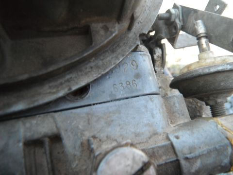 1972 International Scout II - A close-up view of a carburetor part, showing stamped identification numbers.