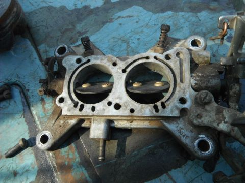 1972 International Scout II - Close-up of a carburetor, showing its internal components and metal construction.