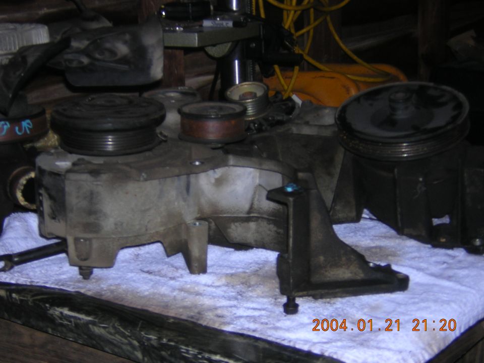 Alternator and power steering pump assembly on a white cloth