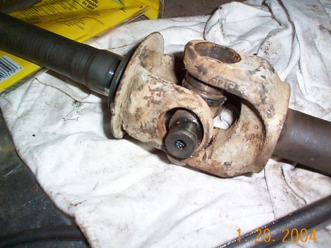 1992 Ford Bronco - A close-up view of a worn driveshaft universal joint, likely undergoing maintenance or repair.