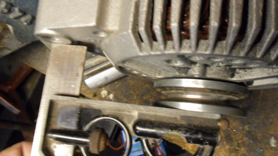 Close-up of an alternator pulley and part of the unit