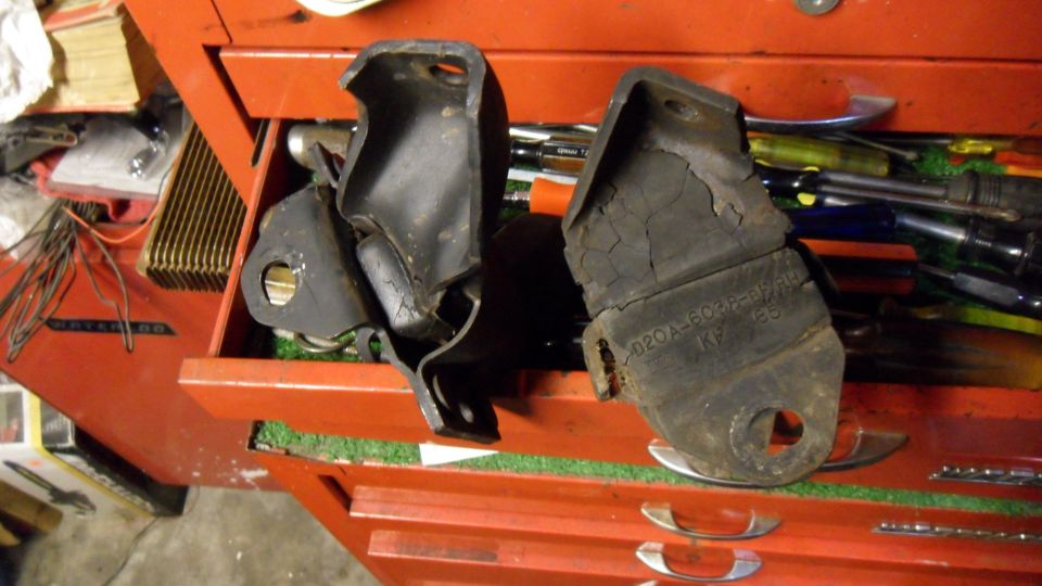 Two worn engine mounts, one with visible part number 020A-6034-BA