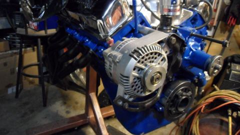 1972 Ford Ranchero - Engine assembly with alternator and exhaust headers, mounted on an engine stand.