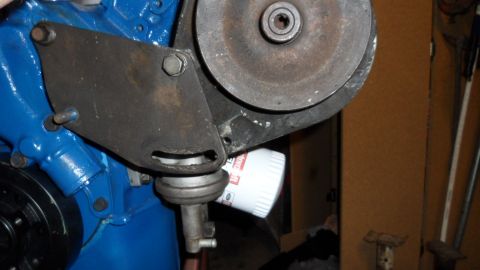 1972 Ford Ranchero - Close-up of an engine component, including a white oil filter and a metal bracket attached to a pulley.