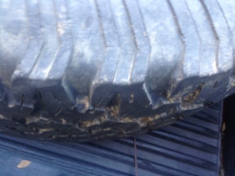 1986 Ford Bronco - A close-up view of a worn tire tread and sidewall, showing damage.