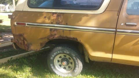 1979 Ford Bronco - This 1978 Ford Bronco shows extensive rust damage on its rear quarter panel and lower body.
