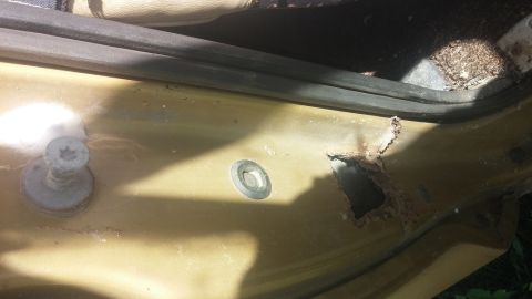 1979 Ford Bronco - Rust has eaten through the interior door panel of this vehicle, revealing damage.