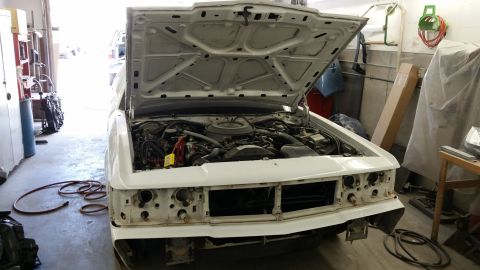 1991 Ford LTD Crown Victoria - Front view of a 1991 Ford Crown Victoria LTD in a garage, undergoing repairs with the hood open.
