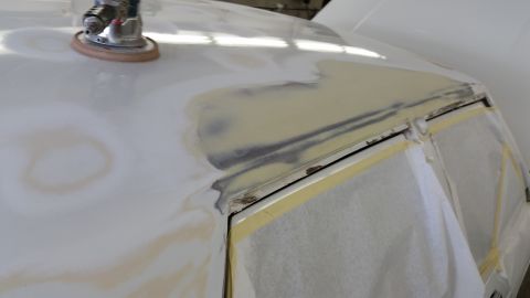 1991 Ford LTD Crown Victoria - Body panel repair in progress, showing sanding and masking tape application.