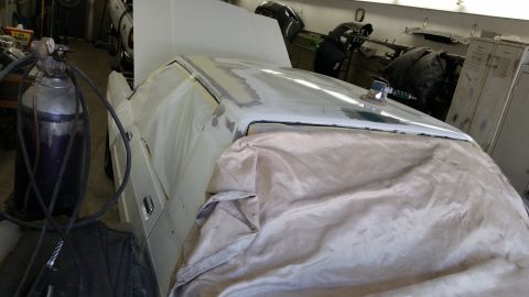 1991 Ford LTD Crown Victoria - Car undergoing bodywork repairs in a workshop, with equipment present.