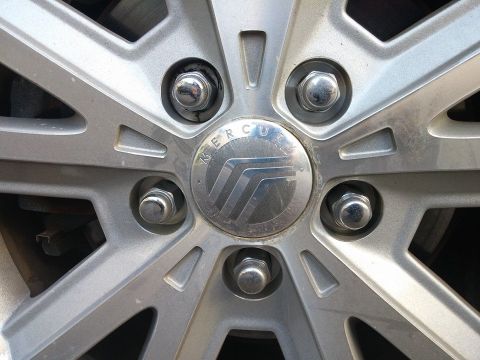 2000 Mercury Grand Marquis - Mercury wheel center cap with logo visible.