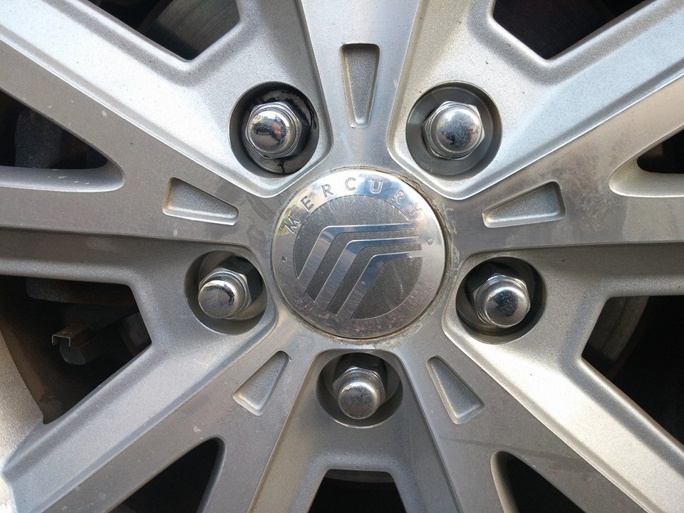 Close-up of a Mercury wheel center cap with the Mercury logo