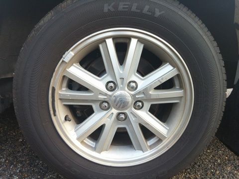 2000 Mercury Grand Marquis - A close-up view of a car's wheel and tire, the Mercury logo on the center cap.