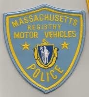 1991 Ford LTD Crown Victoria - Photograph of an embroidered Massachusetts Registry of Motor Vehicles Police uniform patch, not a document.