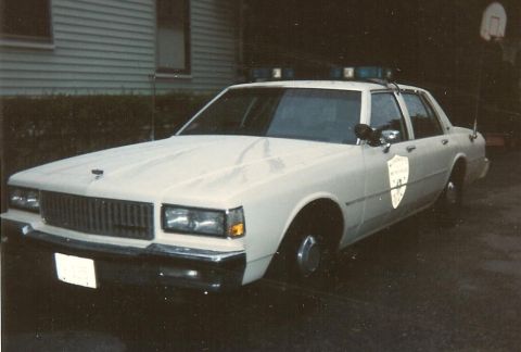 1991 Ford LTD Crown Victoria - This police car appears to be from the 1980s, not a 1991 Ford Crown Victoria LTD.