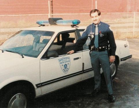1991 Ford LTD Crown Victoria - A Massachusetts police officer poses with a patrol car, likely from the 1980s or early 1990s.