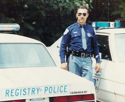 1991 Ford LTD Crown Victoria - Massachusetts Registry Police officer poses with a Crown Victoria patrol car.