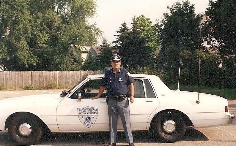 White 1991 Ford Crown Victoria LTD police car with Massachusetts Registry of Motor Vehicles emblem on the door